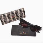 Black cat eye sunglasses with a patterned case and branded pouch on a white background