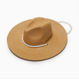 Brown straw hat with a pearl chin strap on a white background