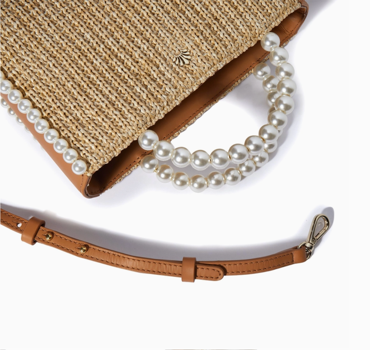 Straw handbag with pearl strap on a white background