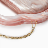 Gold chain with a pink marbled bag 