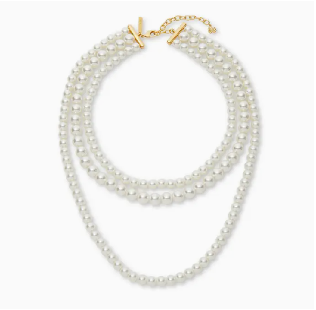 Multi-layered pearl necklace with a gold clasp on a white background