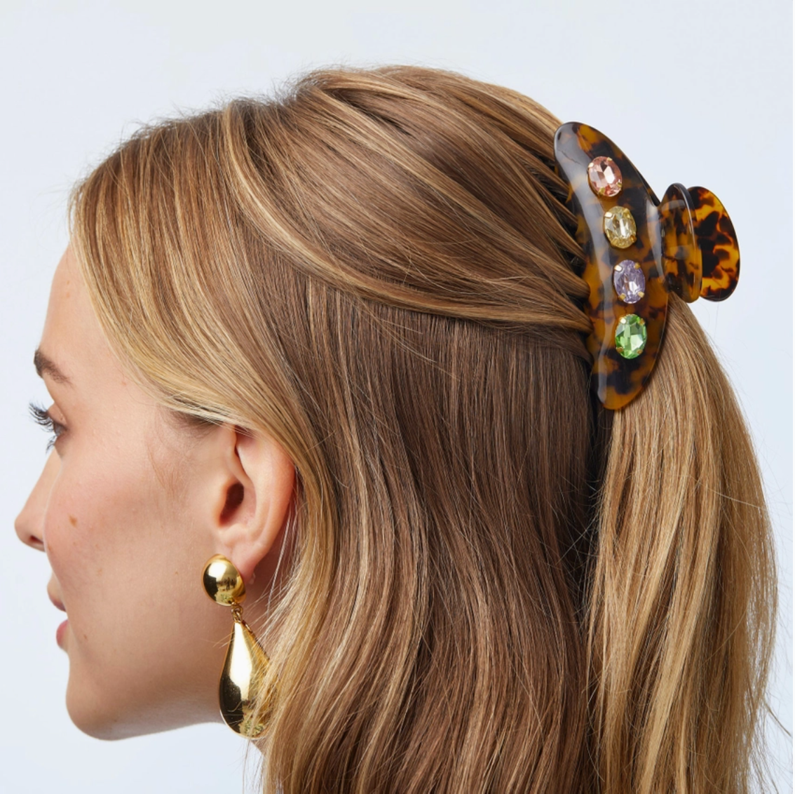 Woman with a decorative hair clip in her blonde hair on a white background