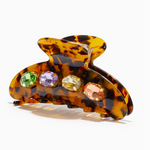 Tortoiseshell hair clip with colored gemstones on a white background