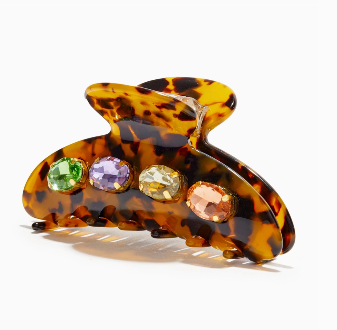 Tortoiseshell hair clip with colored gemstones on a white background