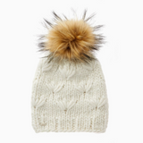 White knitted beanie with a large fur pom-pom on a white background