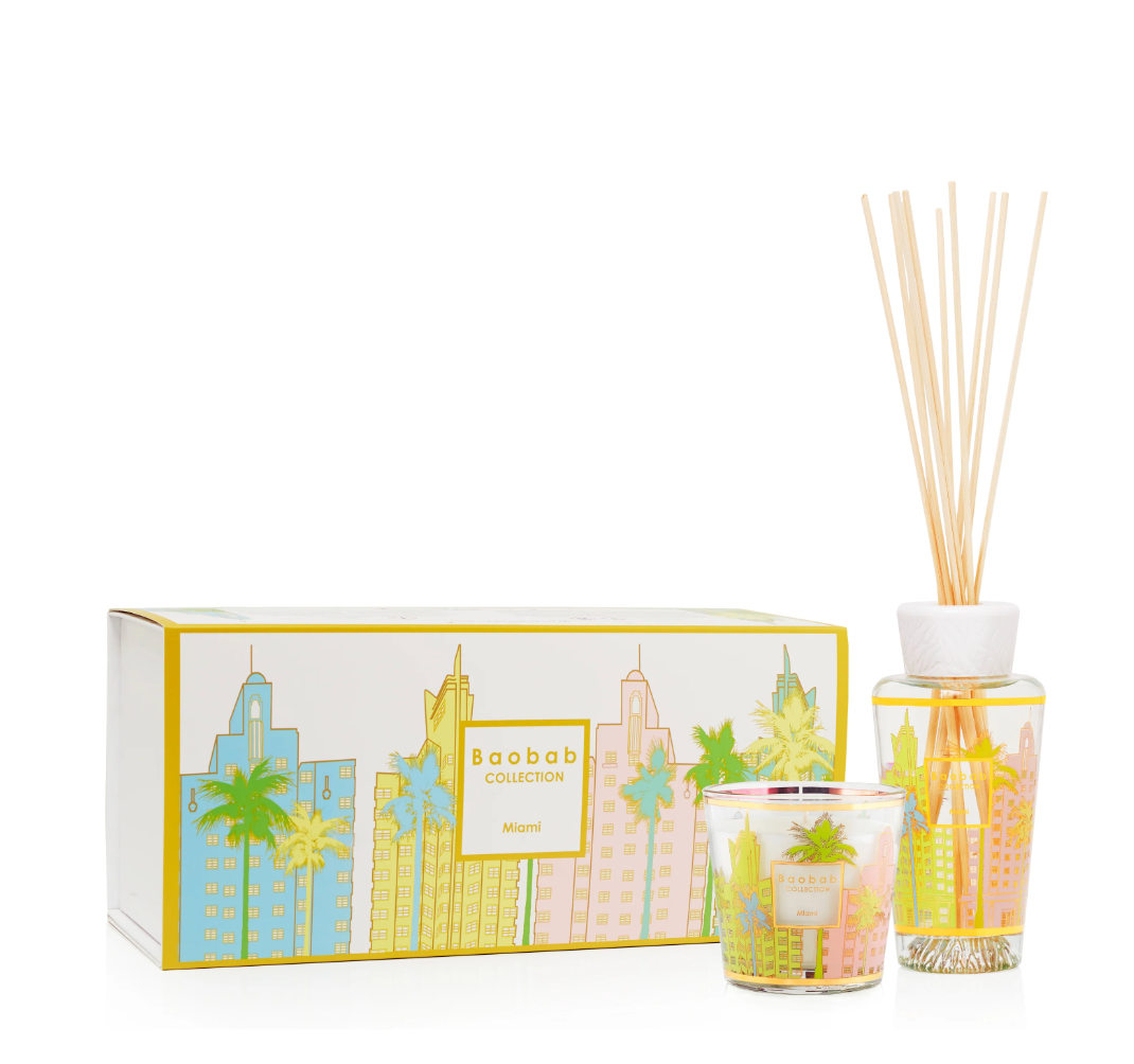 Scented candle and diffuser set with cityscape design packaging on a white background