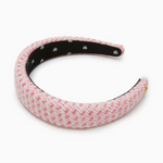 Pink textured headband with a black internal band on a white background