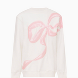 White sweater with a pink bow design on a white background