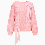 Pink cable knit sweater with a tie detail on a white background