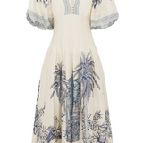 White dress with blue palm tree pattern on a white background