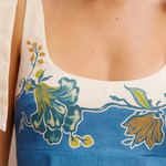 Close-up of a blue and white dress with floral patterns.