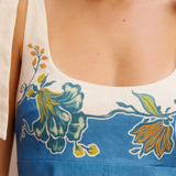 Close-up of a blue and white dress with floral patterns.