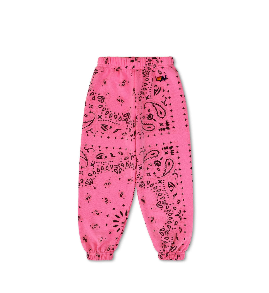 Pink sweatpants with black bandana pattern on a white background