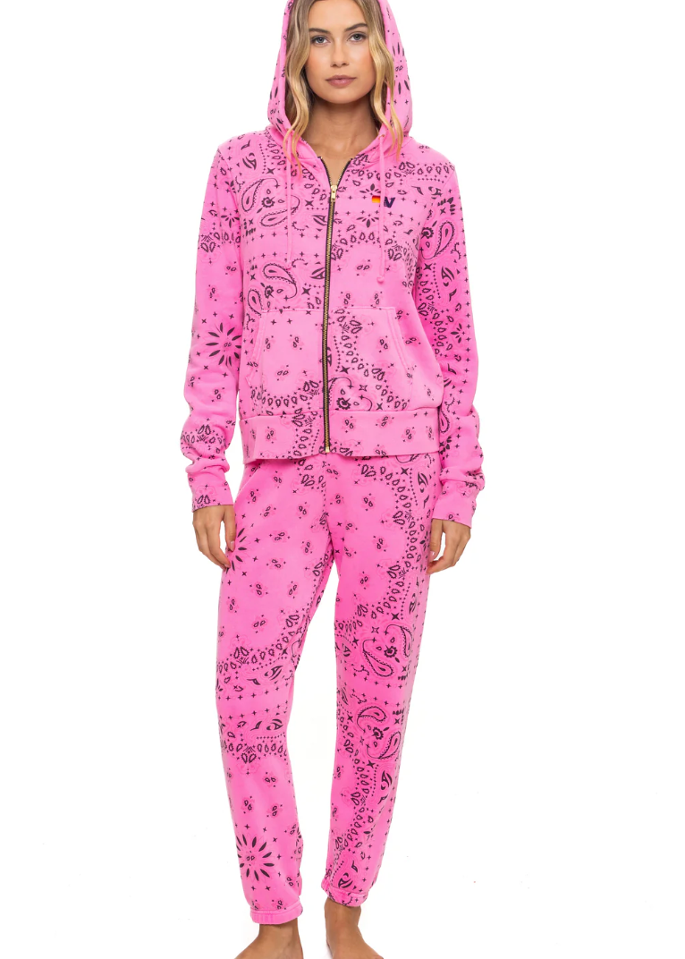 Pink swear set with a pattern worn by a model on a white background