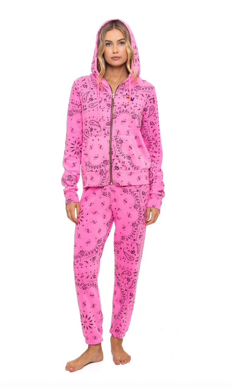 Pink sweat set with a pattern worn by a model on a white background