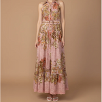 Floral dress on a model against a brown background