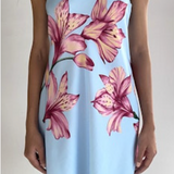 Light blue strapless dress with pink floral pattern worn by a person on a plain background