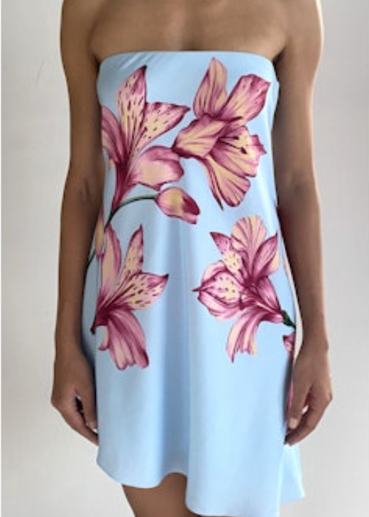 Light blue strapless dress with pink floral pattern worn by a person on a plain background