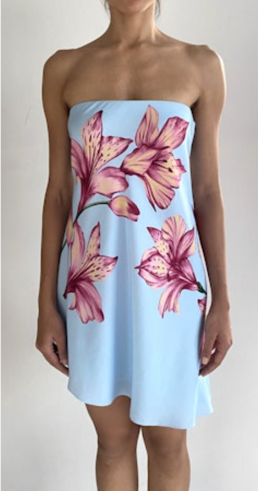 Light blue strapless dress with pink floral pattern worn by a person on a plain background