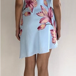 Light blue strapless dress with pink floral pattern worn by a person on a plain background