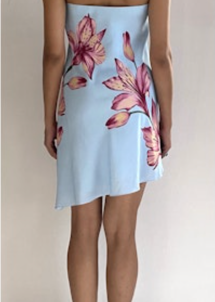 Light blue strapless dress with pink floral pattern worn by a person on a plain background