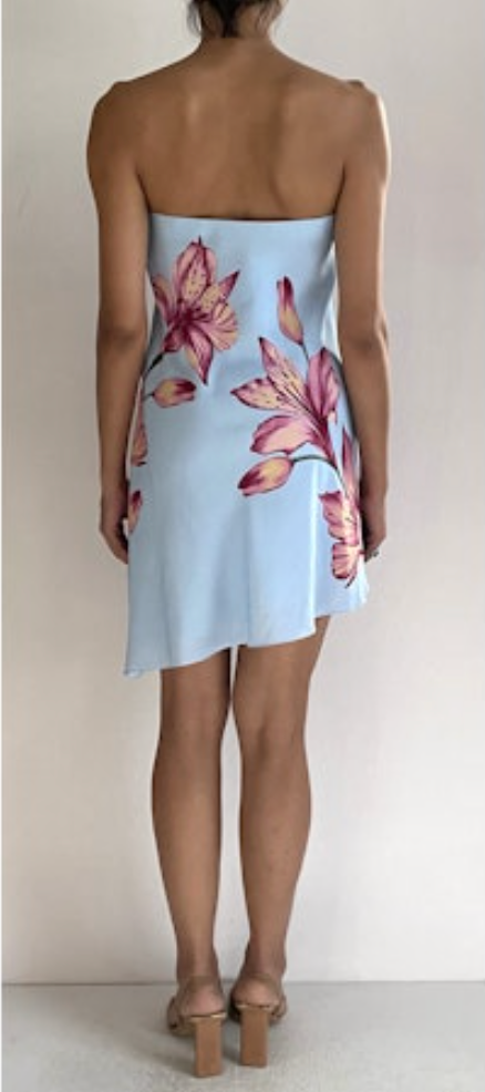 Light blue strapless dress with pink floral pattern worn by a person on a plain background