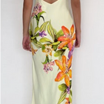 Woman wearing a floral slip dress with a white background
