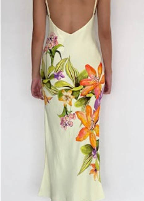 Woman wearing a floral slip dress with a white background