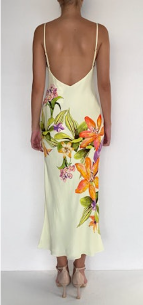 Woman wearing a floral slip dress with a white background