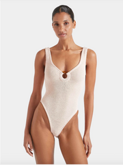 Woman wearing a cream knitted swimsuit on a white background