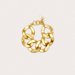 Gold chain bracelet on a light beige background