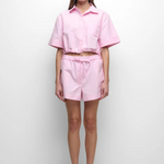 Person wearing a pink outfit on a white background