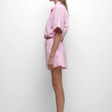 Woman wearing a pink outfit with a white background
