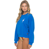 Woman wearing a blue sweatshirt with a logo on a white background