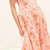 Peach floral dress on a white background