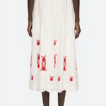 White skirt with red patterns worn by a model on a white background