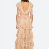 Woman wearing a beige ruffled dress on a white background