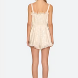 Woman wearing a cream lace dress on a white background