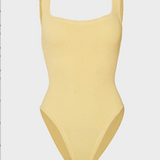 Yellow ribbed swimsuit on a light gray background