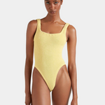 Woman wearing a yellow swimsuit on a white background