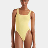 Woman wearing a yellow swimsuit on a white background