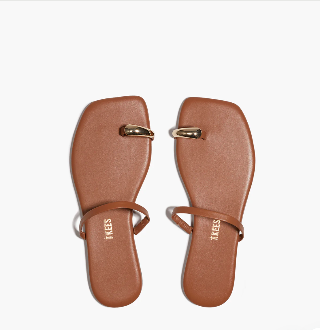 Pair of brown sandals with gold accents on a white background