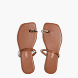 Pair of brown sandals with gold accents on a white background