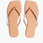 Pair of beige flip-flops on a white background