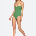 Woman wearing a green swimsuit on a white background