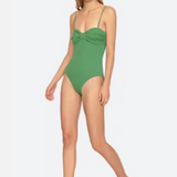 Woman wearing a green swimsuit on a white background