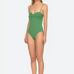 Woman wearing a green swimsuit on a white background