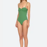 Woman wearing a green swimsuit on a white background