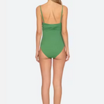 Woman wearing a green swimsuit on a white background