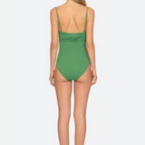 Woman wearing a green swimsuit on a white background